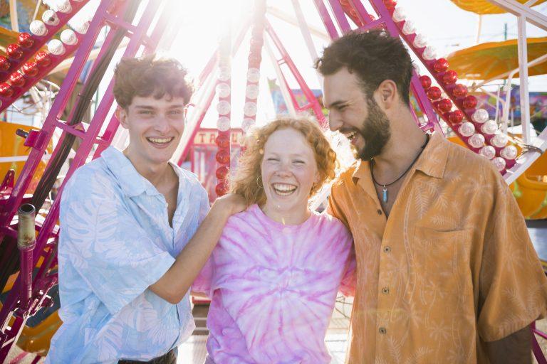 Image with three happy friends in an amusement park