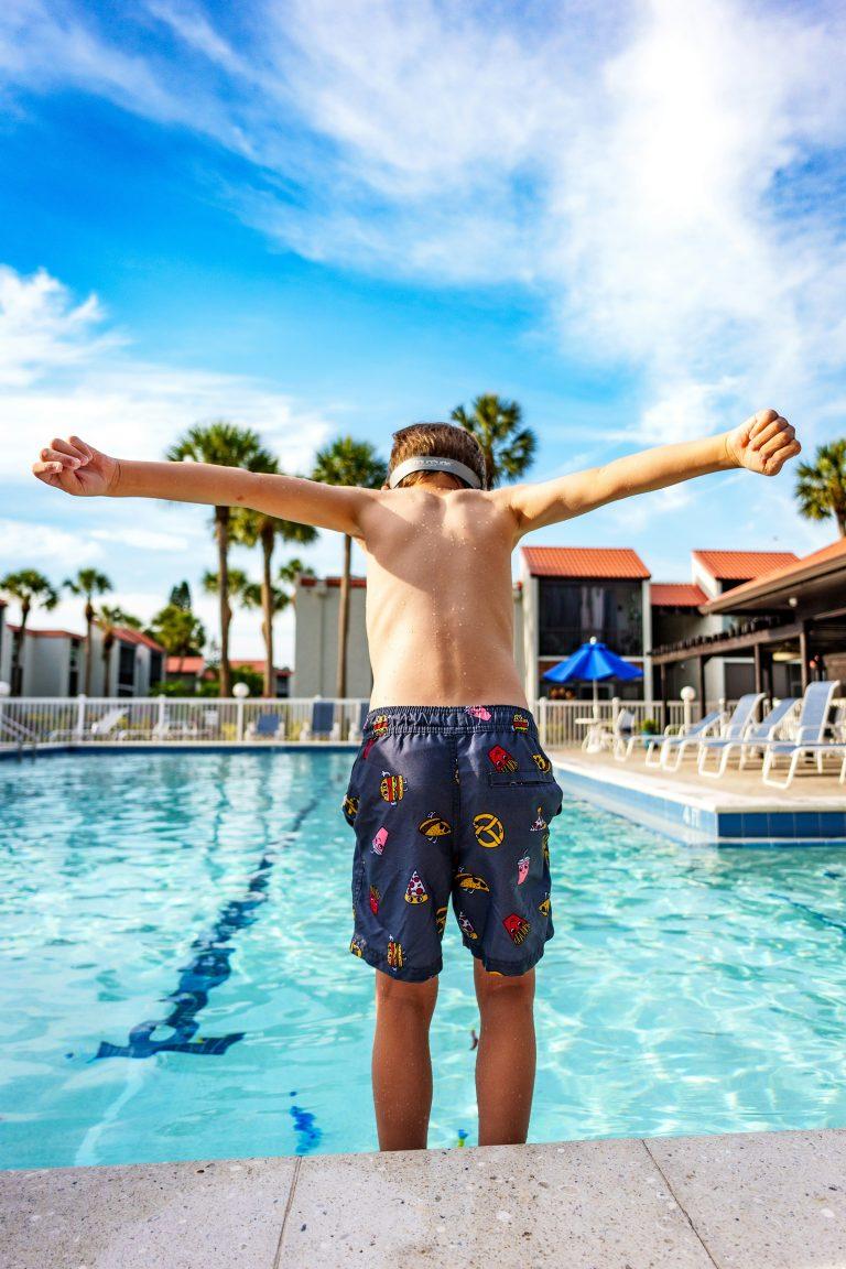 Image of a child who is jumping into a pool